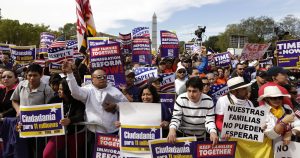 Photo of people and signs at immigration rally