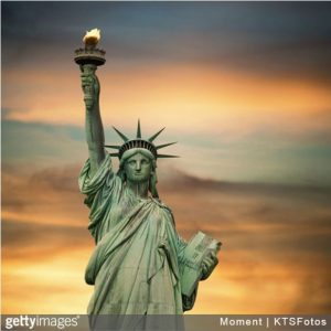 Statue of Liberty with sun setting in the background